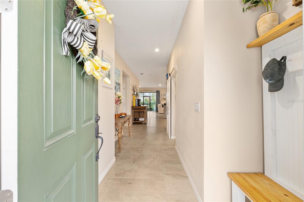 An entryway features a green door, tile flooring, and a built-in bench with a shelf — 8566 SW 79TH AVENUE, OCALA, FL