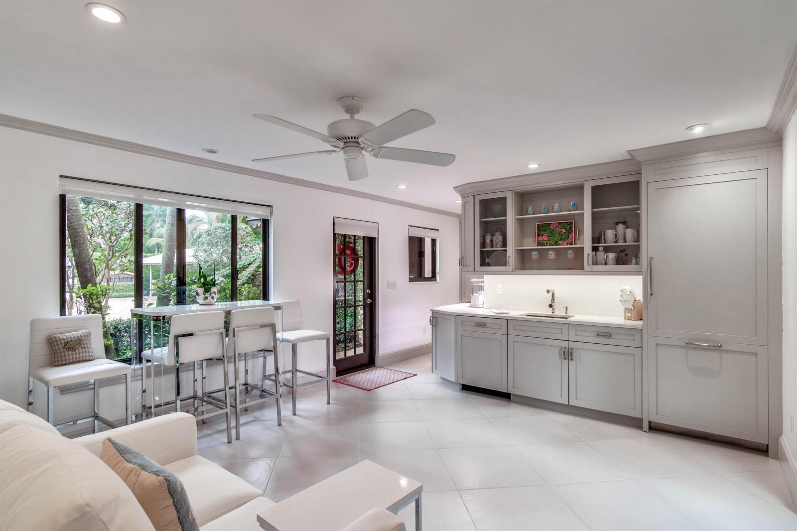 A bright kitchen and living area features light gray cabinetry, white tile floors, and bar seating — 226 Chilean Avenue # 4, Palm Beach FL 33480, PALM BEACH, FL