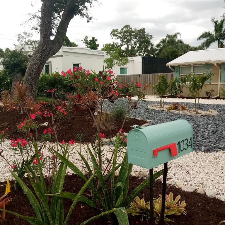 A light blue mailbox stands in a landscaped front yard with dark and white gravel — 1034 N 22ND STREET, SARASOTA, FL