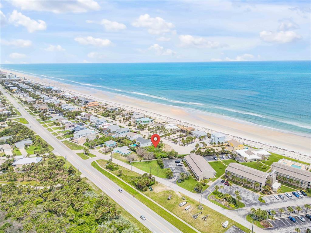 An aerial view shows a coastal property marked with a pin near the beach — 4732 VAN KLEECK DRIVE, NEW SMYRNA BEACH, FL