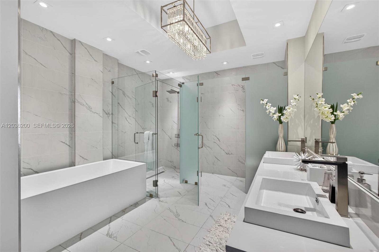 A modern bathroom features a glass-enclosed shower, a freestanding tub, and double vessel sinks — 3100 N Ocean Dr # 1801, Singer Island FL 33404, SINGER ISLAND, FL