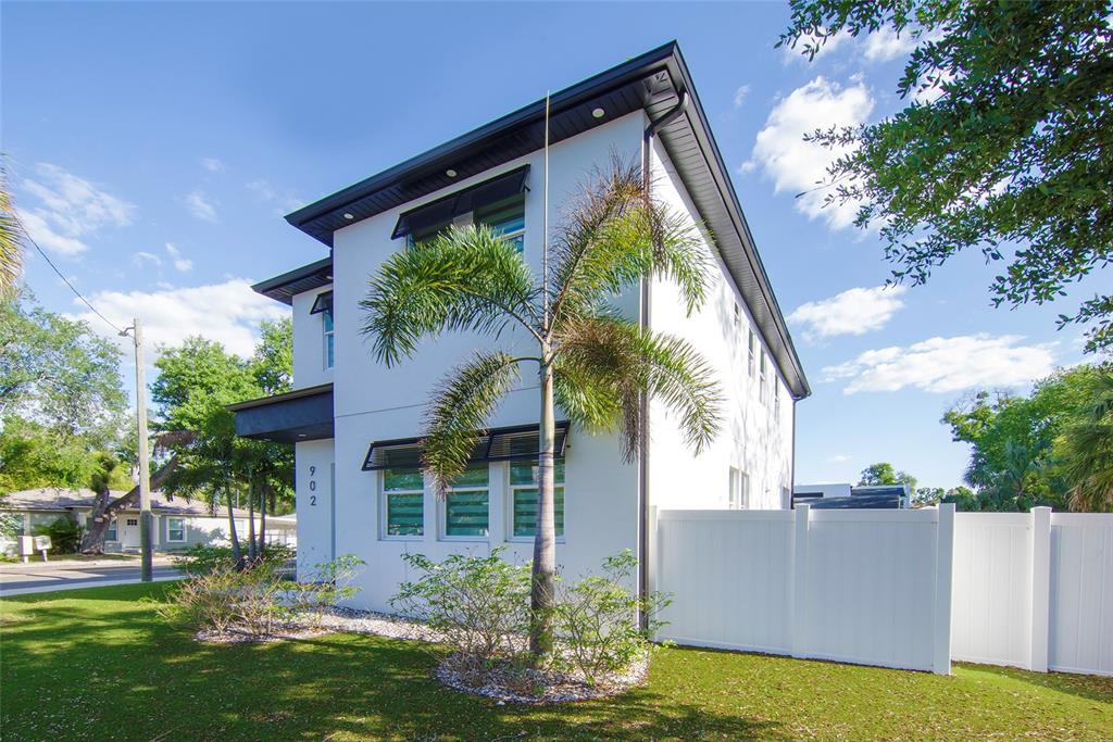 A two-story white modern house features a palm tree in the front yard — 902 W SLIGH AVENUE, TAMPA, FL