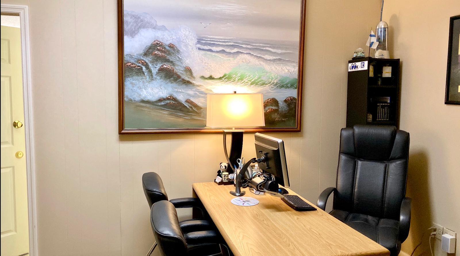 A home office features a wooden desk, black chairs, a table lamp, and wall art — 934 S Dixie Highway # 934, Lantana FL 33462, LANTANA, FL