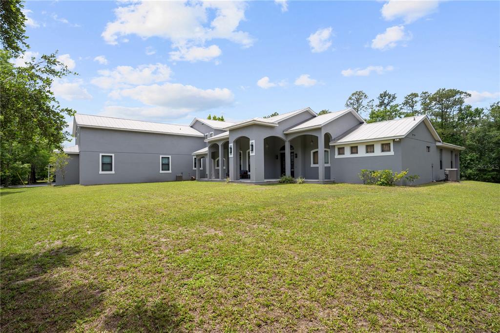A gray, single-story house with a metal roof and a covered front porch — 5920 EDGERTON AVENUE, ORLANDO, FL
