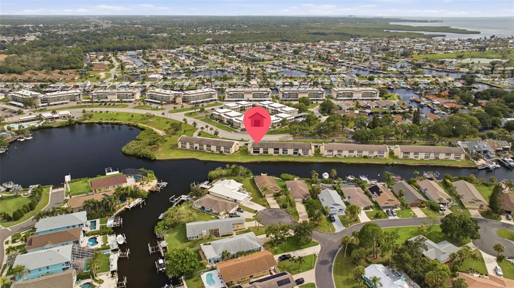 An aerial view shows a multi-unit residential building marked with a red pin — 4555 MARINE PARKWAY UNIT 106, NEW PORT RICHEY, FL