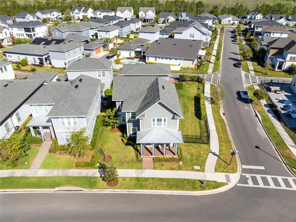 An aerial view shows a gray two-story house with a front porch on a corner lot — 6665 BRIDGMAN STREET, ORLANDO, FL