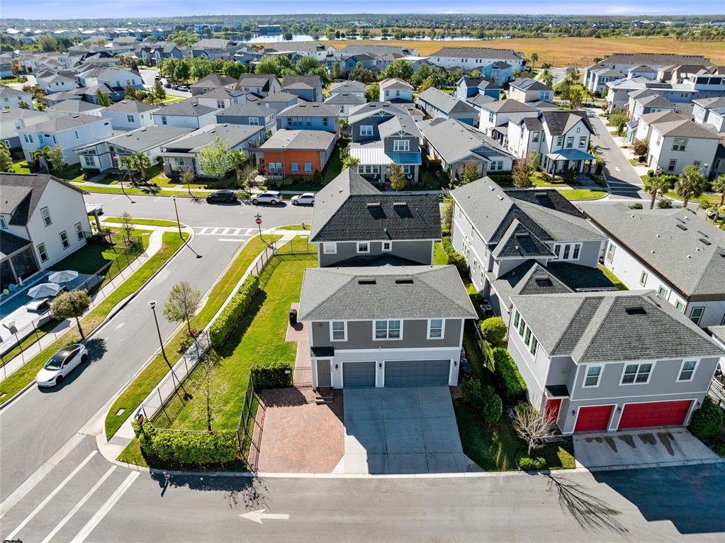 An aerial view of a suburban house with a gray exterior, two-car garage, and driveway — 6665 BRIDGMAN STREET, ORLANDO, FL