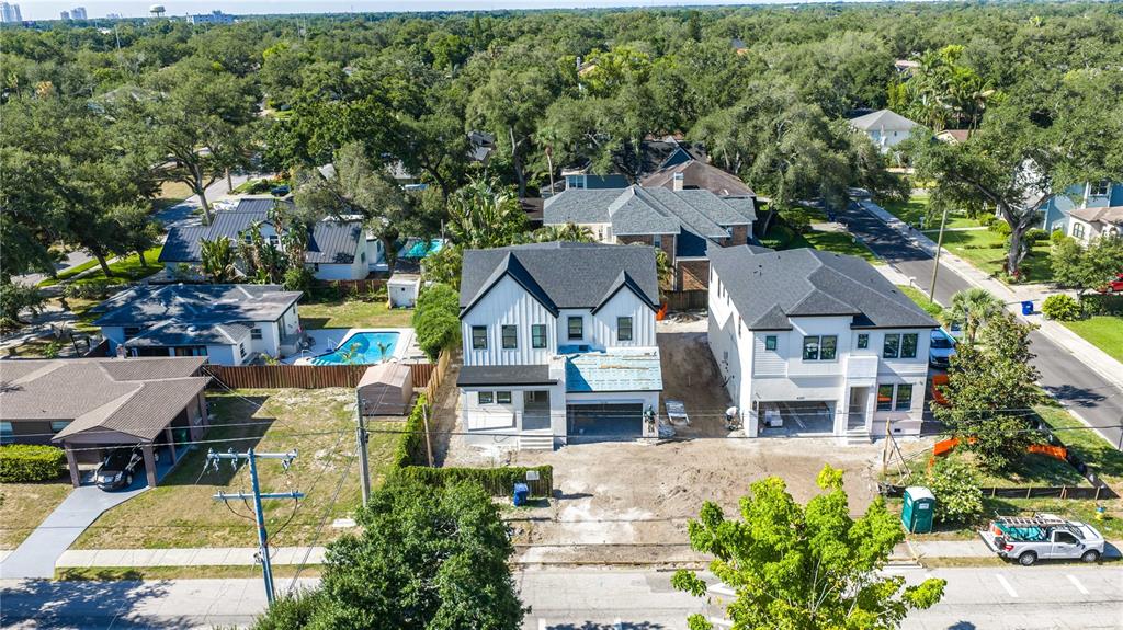 An aerial view shows two modern, newly constructed houses under development in a residential neighborhood — 4018 W CLEVELAND STREET, TAMPA, FL