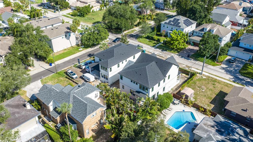 An aerial view shows several residential houses, including one with a backyard swimming pool — 4018 W CLEVELAND STREET, TAMPA, FL