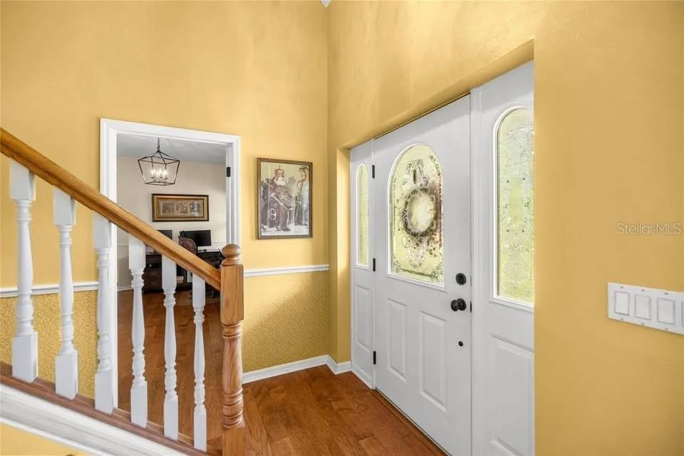 A front porch with concrete steps leads to a green door with glass sidelights — 10264 W SPRINGTREE LANE, CRYSTAL RIVER, FL