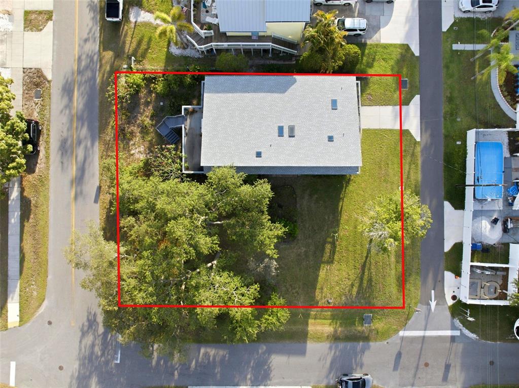 An aerial view shows a house with a gray roof situated on a grassy lot — 110 GEORGIA AVE. AVENUE, CRYSTAL BEACH, FL