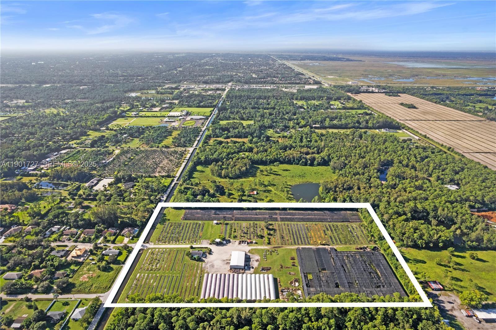 An aerial view shows a rectangular property featuring greenhouses, nursery rows, and agricultural structures — 1535 B Road, FL 33470, FL
