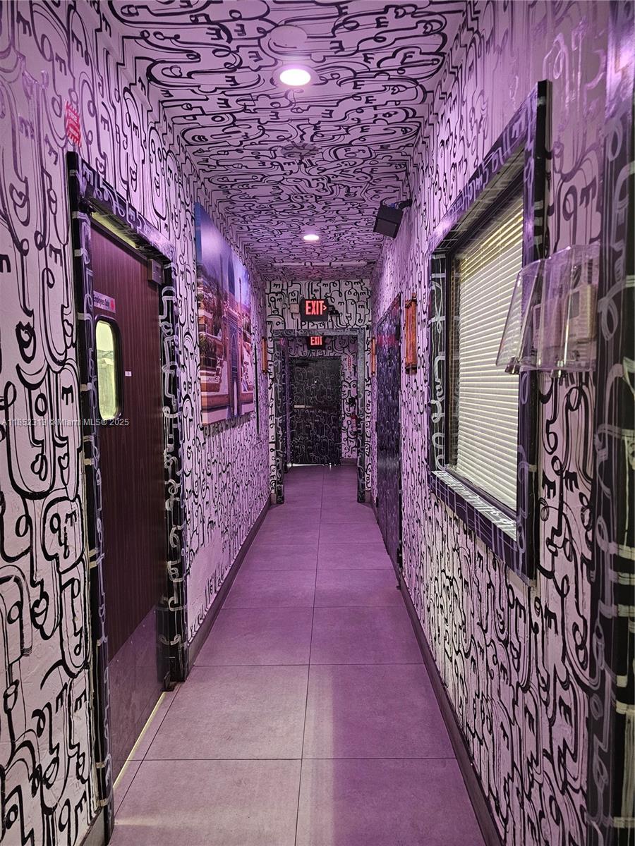 A narrow hallway features walls and ceilings covered in black and white abstract line art — 2995 NE 163rd St, North Miami Beach FL 33160, NORTH MIAMI BEACH, FL