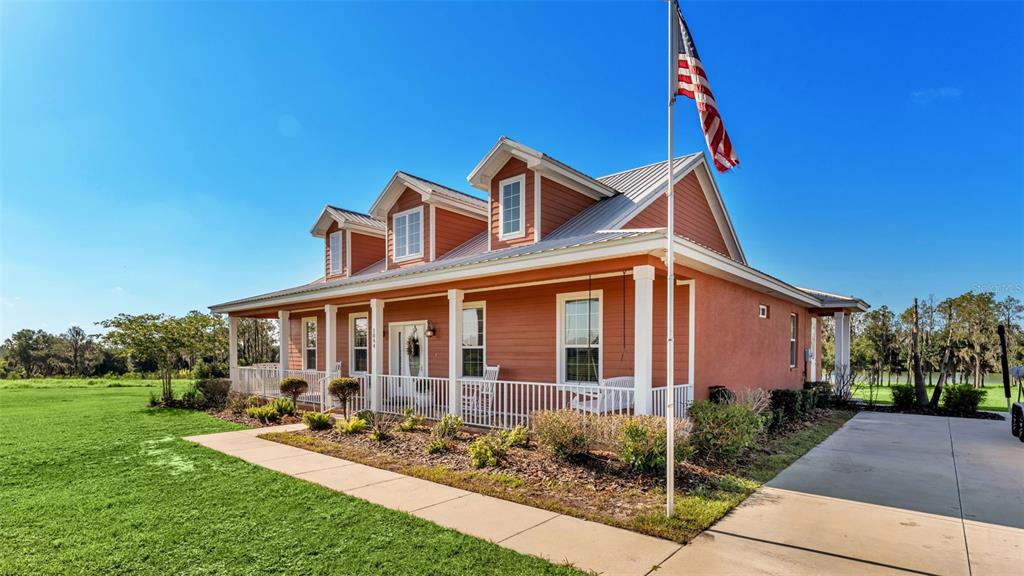 A one-story house with a metal roof, three dormers, and a front porch — 1044 TIMBERS DRIVE, FORT MEADE, FL