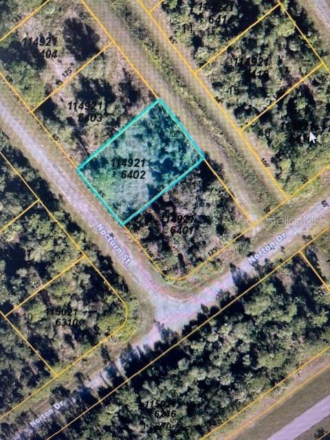 This is an aerial map showing a highlighted vacant residential lot at a street intersection — NOCTURN STREET, NORTH PORT, FL