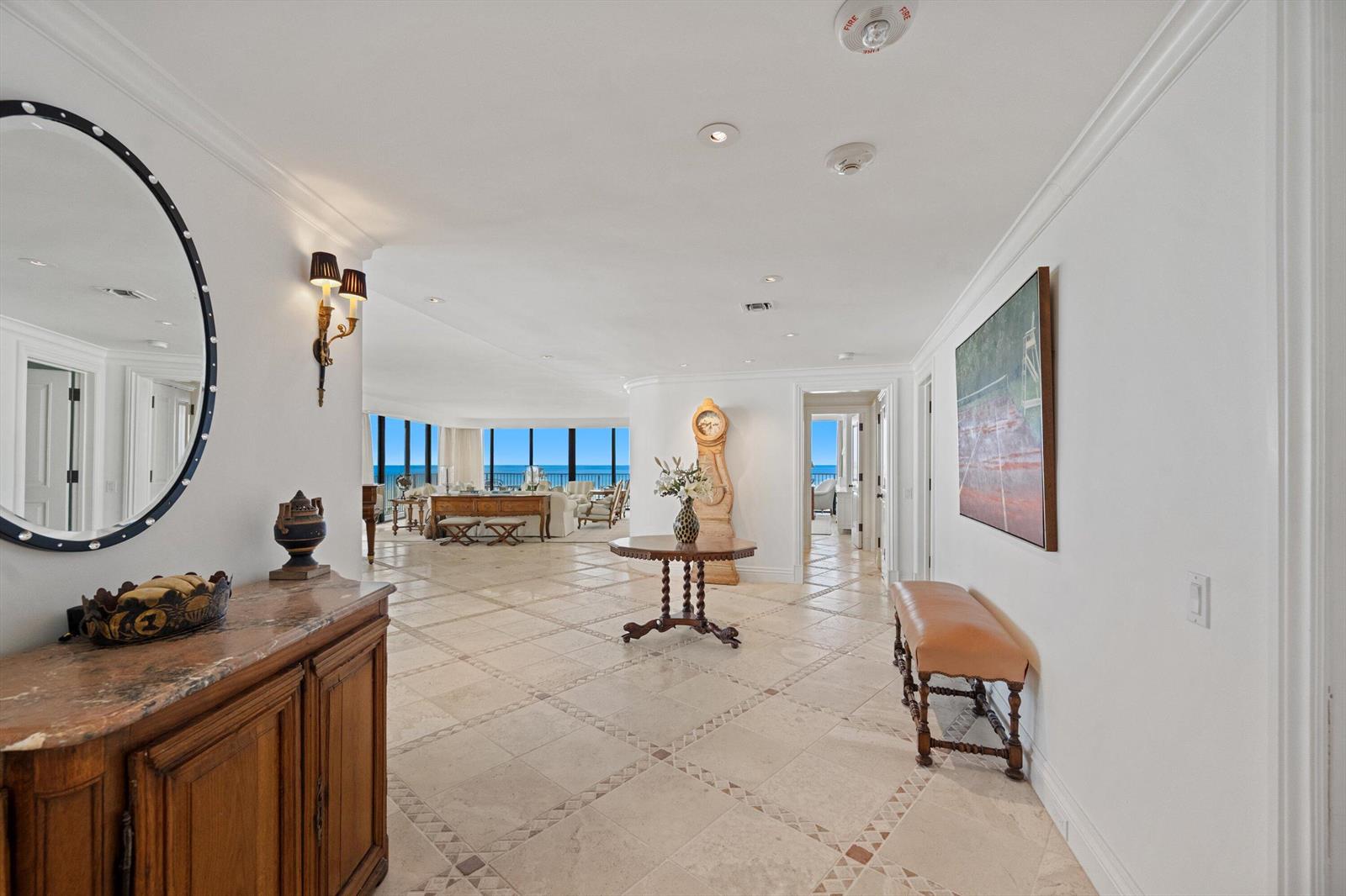 A spacious foyer with stone tile flooring leads to an open living area overlooking the ocean — 150 N Ocean Boulevard # 3, Palm Beach FL 33480, PALM BEACH, FL