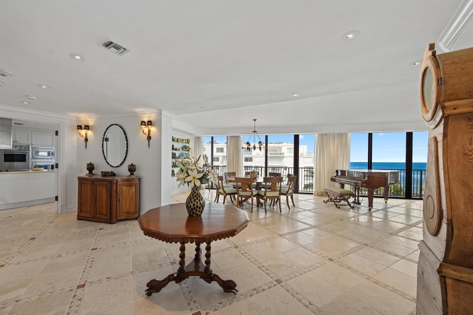 A spacious dining and living area features tile floors, a grand piano, and ocean views — 150 N Ocean Boulevard # 3, Palm Beach FL 33480, PALM BEACH, FL