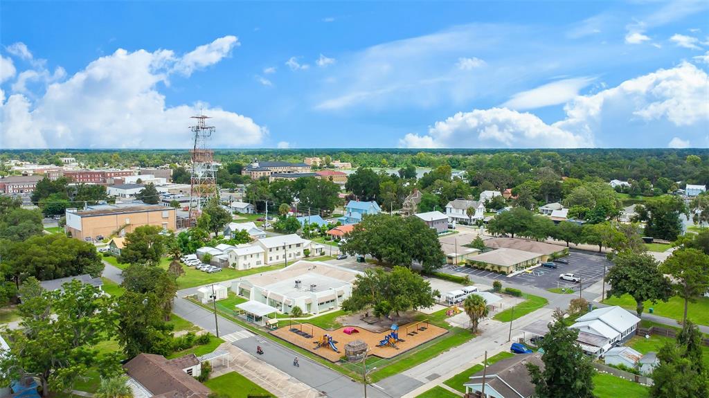 An aerial view shows a small town with a playground, commercial buildings, and residential houses — 258 SW COLUMBIA AVENUE, LAKE CITY, FL