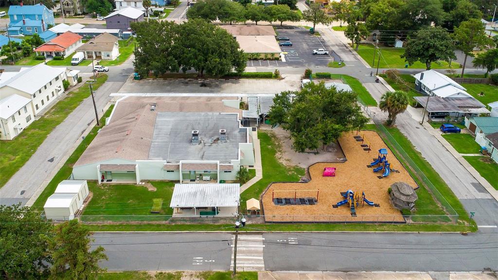 An aerial view shows a building with a playground and parking lot in a neighborhood — 258 SW COLUMBIA AVENUE, LAKE CITY, FL