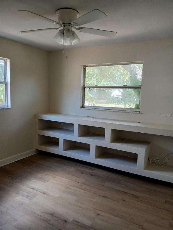 A kitchen with white cabinets, white appliances, and dark countertops features a tiled backsplash — 2834 25TH AVENUE N, ST PETERSBURG, FL