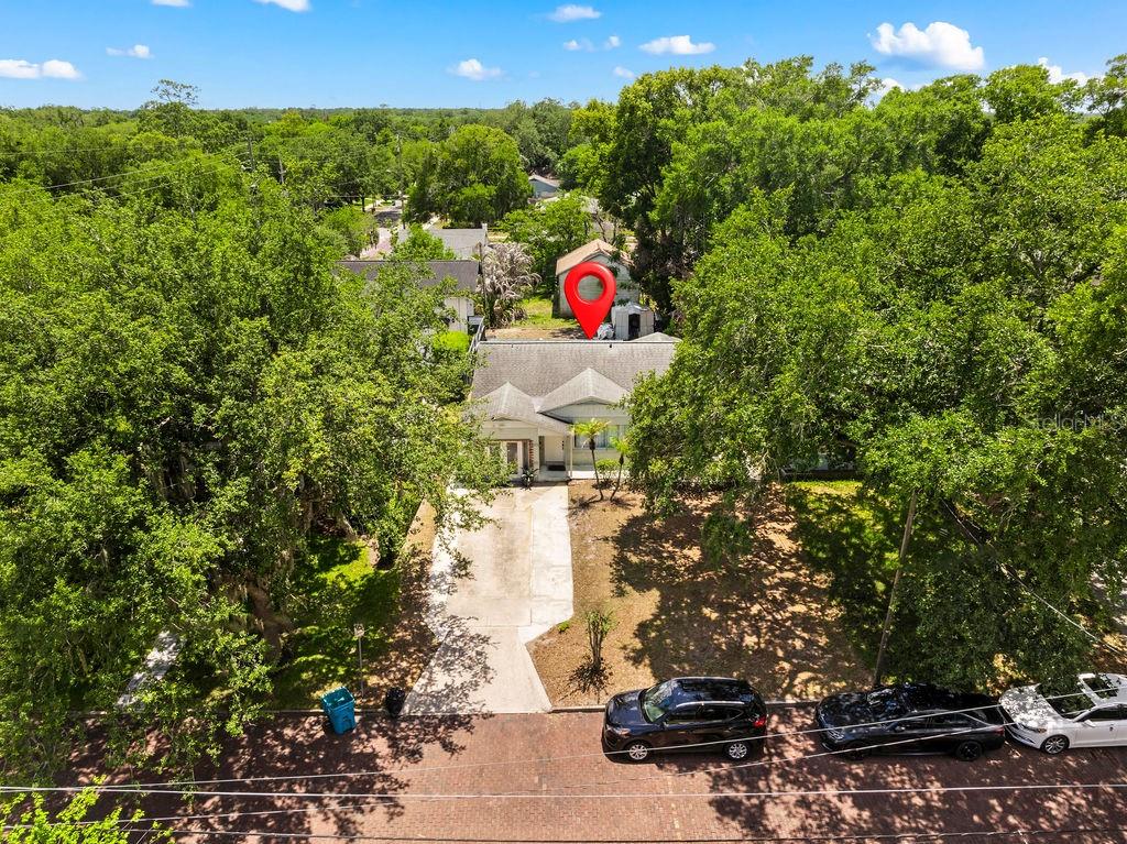 A single-story house with a white stucco exterior, a concrete driveway, and double glass doors — 1518 E JEFFERSON STREET, ORLANDO, FL