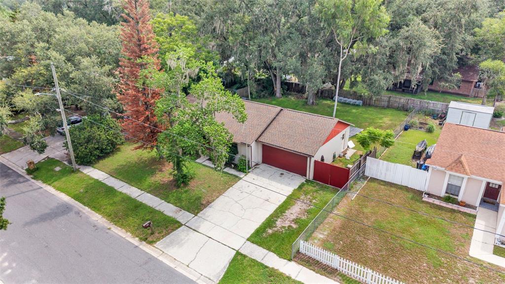 An aerial view of a single-story house with a red garage door and a driveway — 2110 JOHNSON LOOP, PLANT CITY, FL
