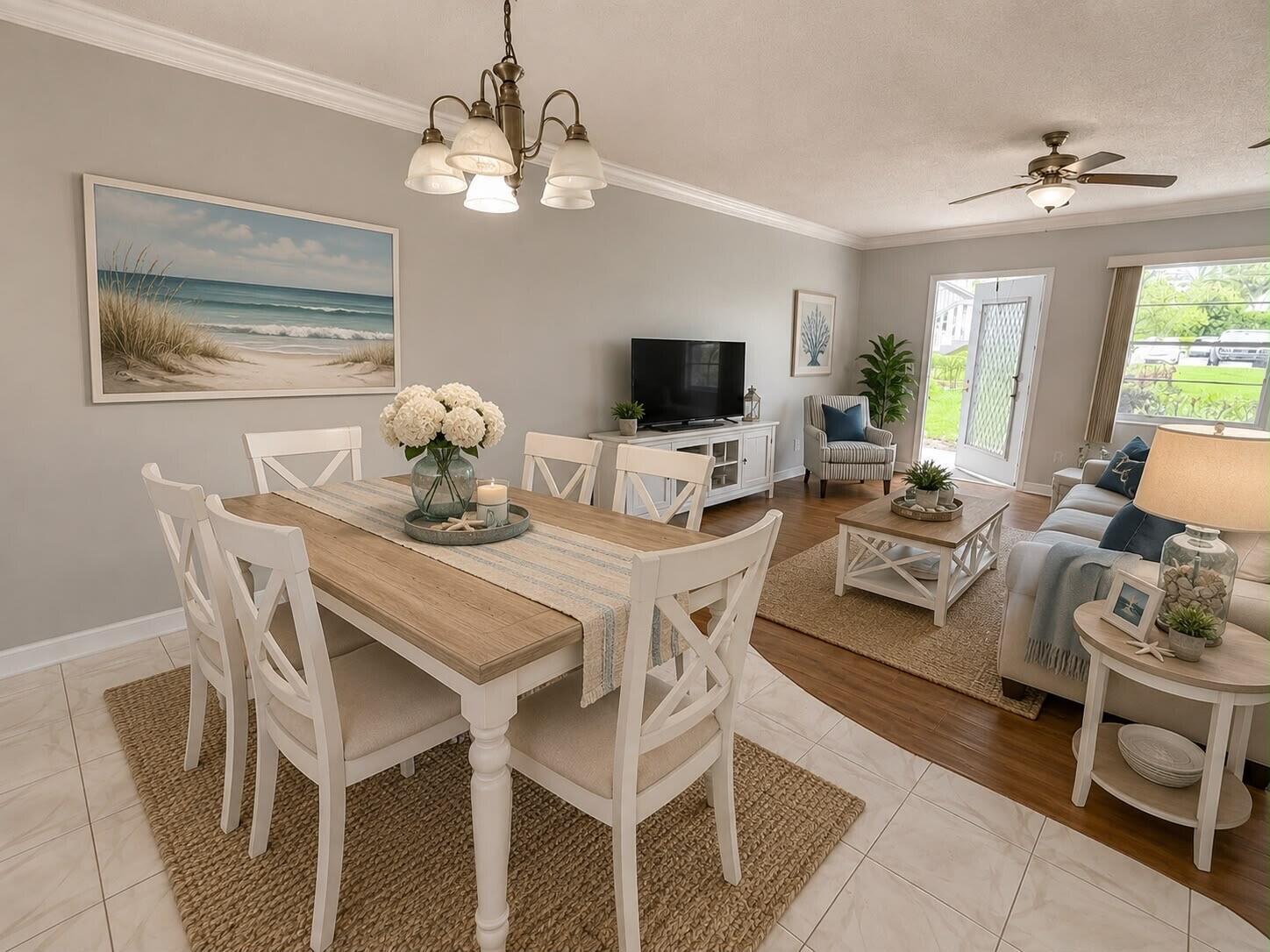 An open-concept living and dining area features light wood furniture, coastal decor, and tile flooring — 261 Suffolk, Boca Raton FL 33434, BOCA RATON, FL