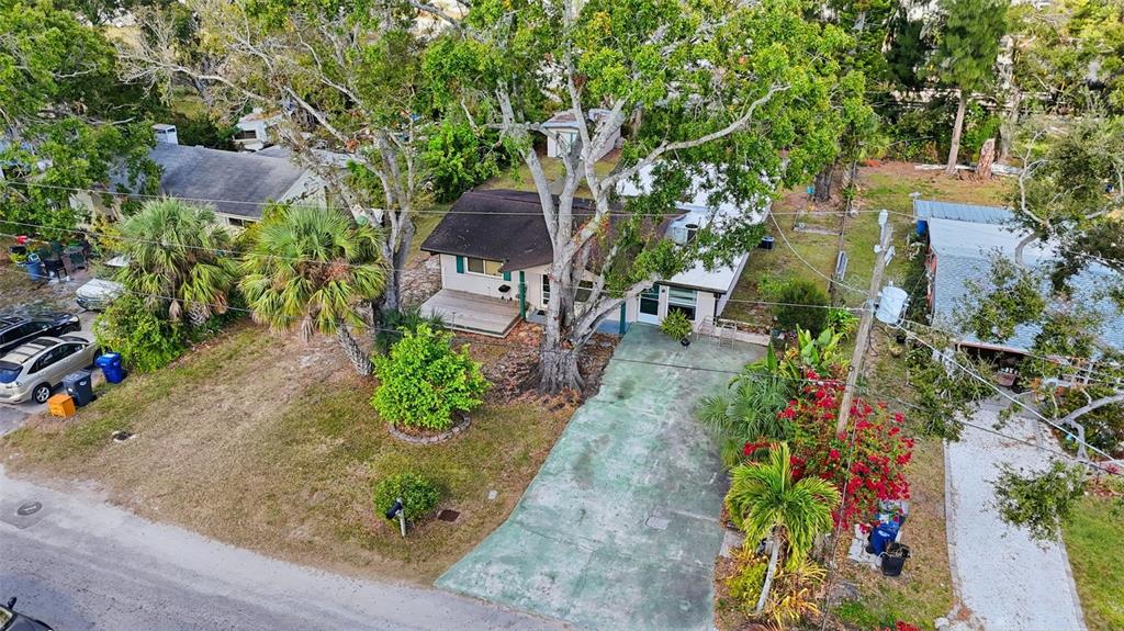An aerial view of a single-story house with a green driveway and large trees — 1619 SUPONIC AVENUE, SARASOTA, FL