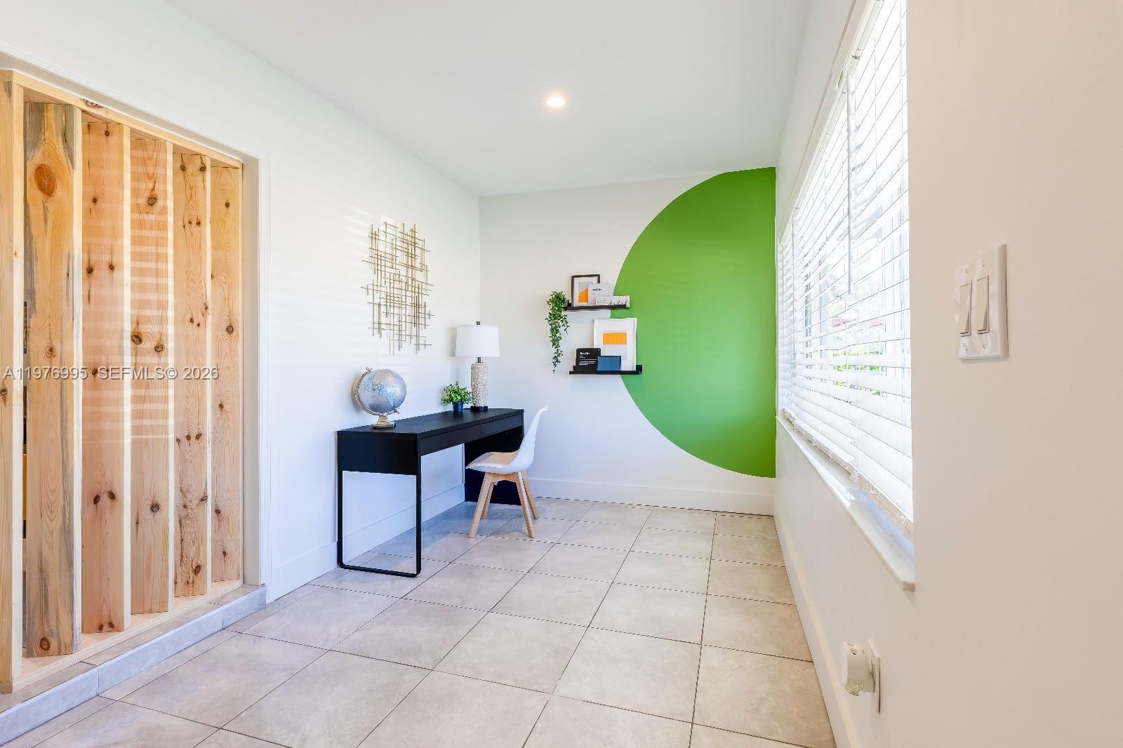 A home office features a black desk, a green circular wall mural, and tiled flooring — 1836 NW 16th Ter, Miami FL 33125, MIAMI, FL