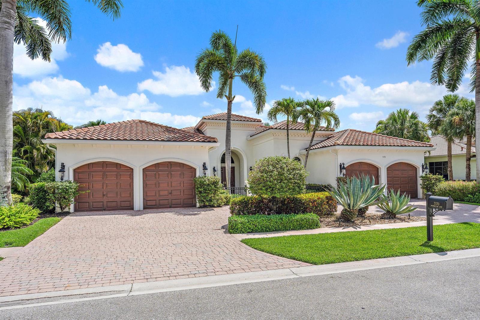 A single-story house with a tile roof, three garage bays, and palm trees in front — 7170 Winding Bay Lane, West Palm Beach FL 33412, WEST PALM BEACH, FL