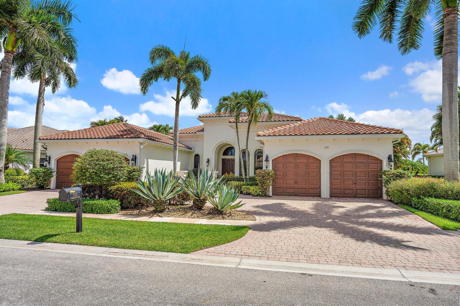 A single-story stucco house with a tile roof, three garage doors, and palm trees — 7170 Winding Bay Lane, West Palm Beach FL 33412, WEST PALM BEACH, FL