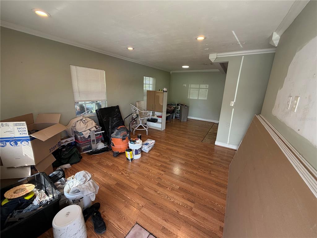 A living room with hardwood floors, recessed lighting, and various boxes and moving supplies — 15331 NW 27TH PLACE, OPA LOCKA, FL