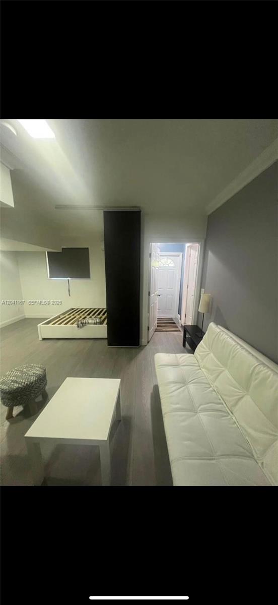 A living area features a white sofa, a coffee table, and a bed frame — 4731 fillmore # 1, Hollywood FL 33021, HOLLYWOOD, FL