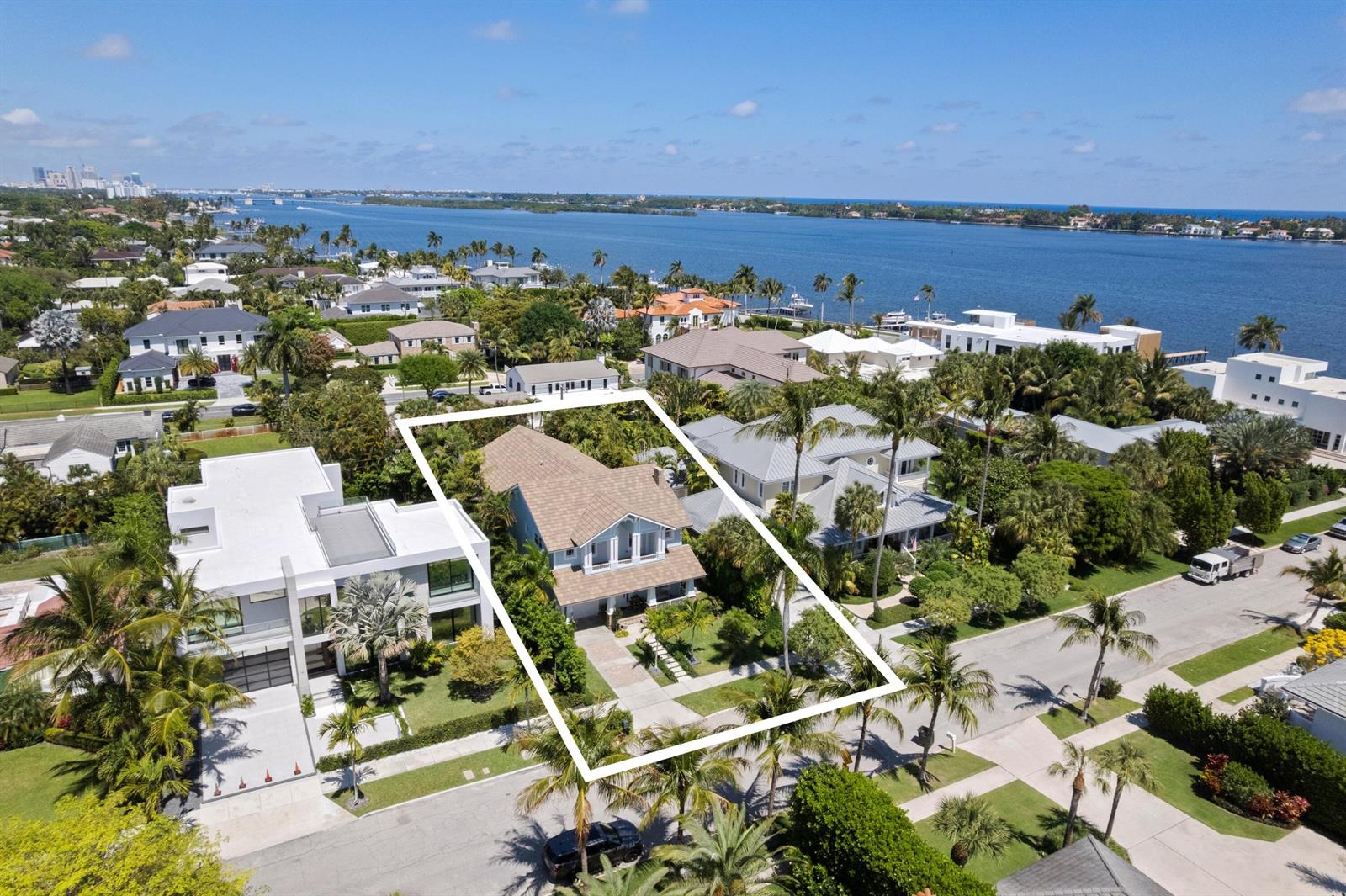 An aerial view shows a two-story house with a brown roof surrounded by tropical landscaping — 137 Cortez Road, West Palm Beach FL 33405, WEST PALM BEACH, FL