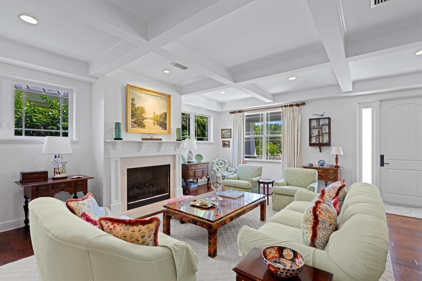 A living room features a fireplace, coffered ceiling, and light-colored furniture on hardwood floors — 137 Cortez Road, West Palm Beach FL 33405, WEST PALM BEACH, FL