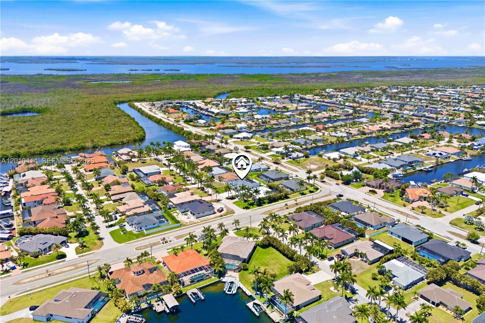 An aerial view shows a residential neighborhood with houses, canals, and surrounding vegetation — OTHER CITY - IN THE STATE OF FLORIDA, FL