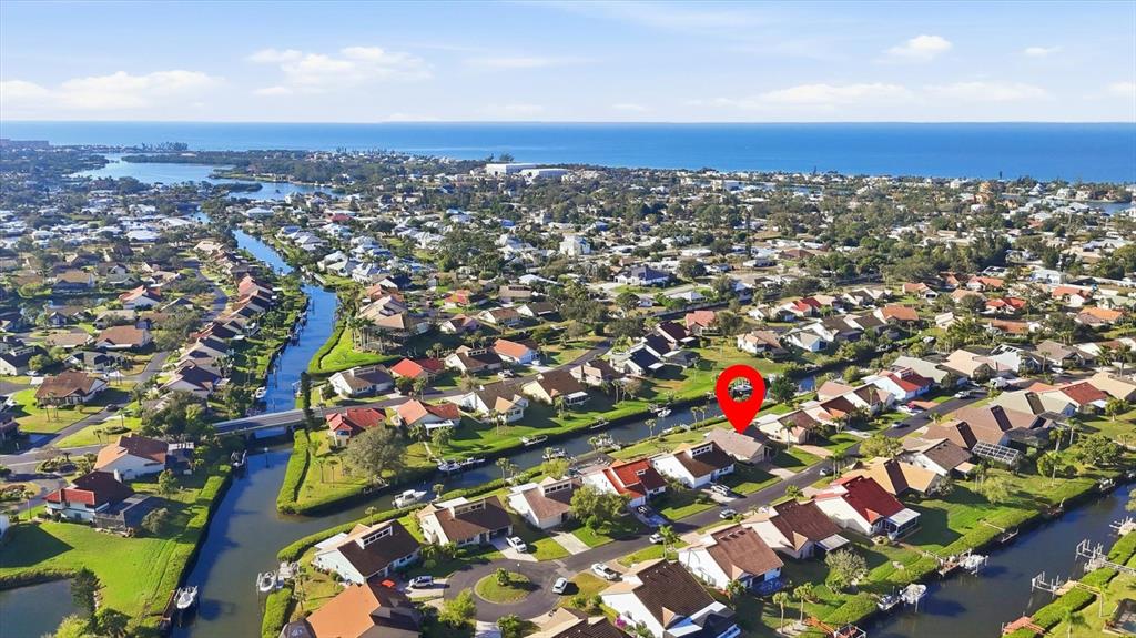 An aerial view shows a residential neighborhood with houses situated along a network of canals — 139 INLETS BOULEVARD UNIT 139, NOKOMIS, FL
