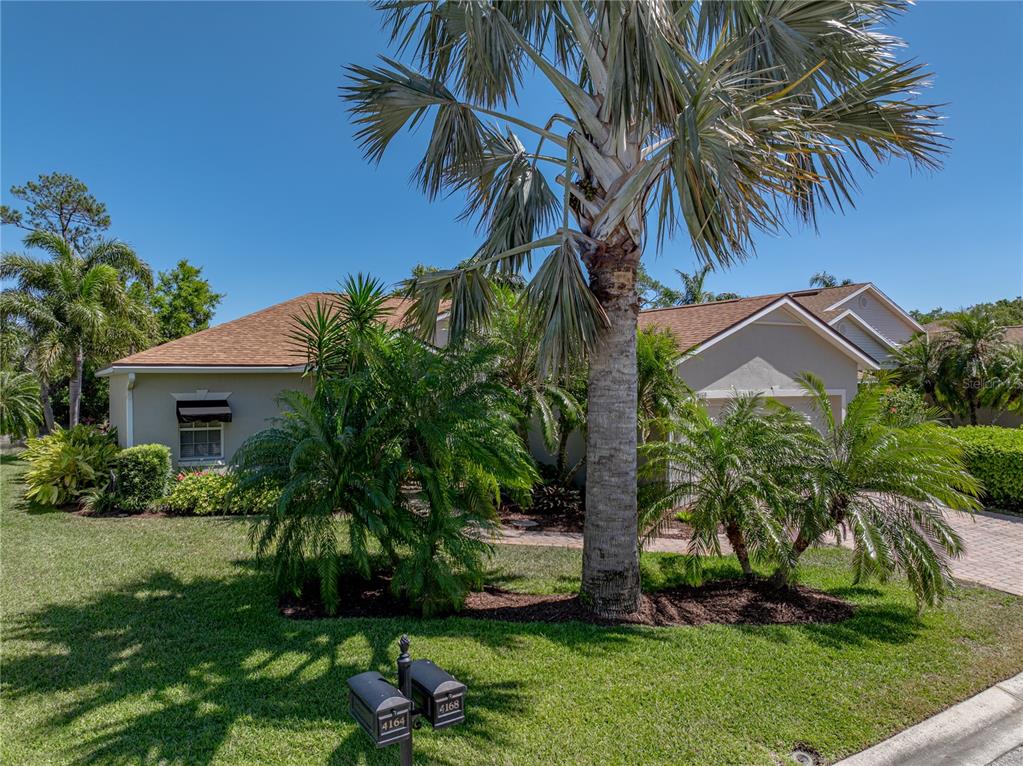 A single-story house with a palm tree in the front yard and two mailboxes — 4168 ABERDEEN LANE, LAKE WALES, FL