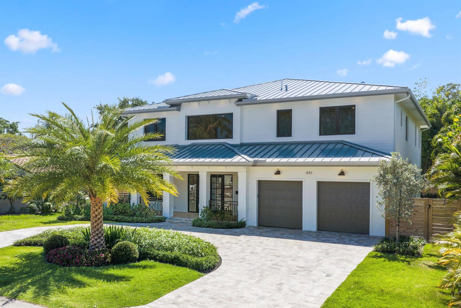 A modern dining area with a wooden table, upholstered chairs, and an open-concept kitchen — 451 NW 7th Avenue, Boca Raton FL 33486, BOCA RATON, FL