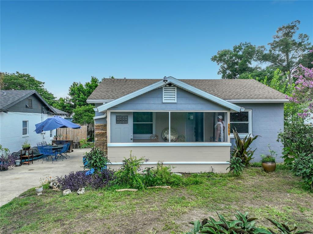 A single-story house with a screened front porch and a concrete side patio — 2509 SHANNON ROAD, ORLANDO, FL