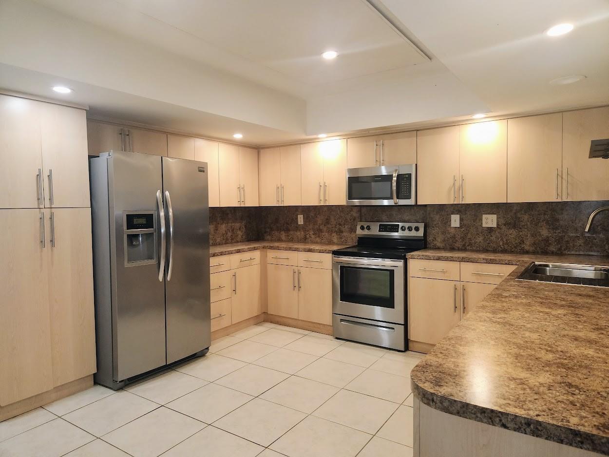 A kitchen with light wood cabinets, stainless steel appliances, and brown laminate countertops — 2940 NE 19th Terrace Side, Lighthouse Point FL 33064, LIGHTHOUSE POINT, FL