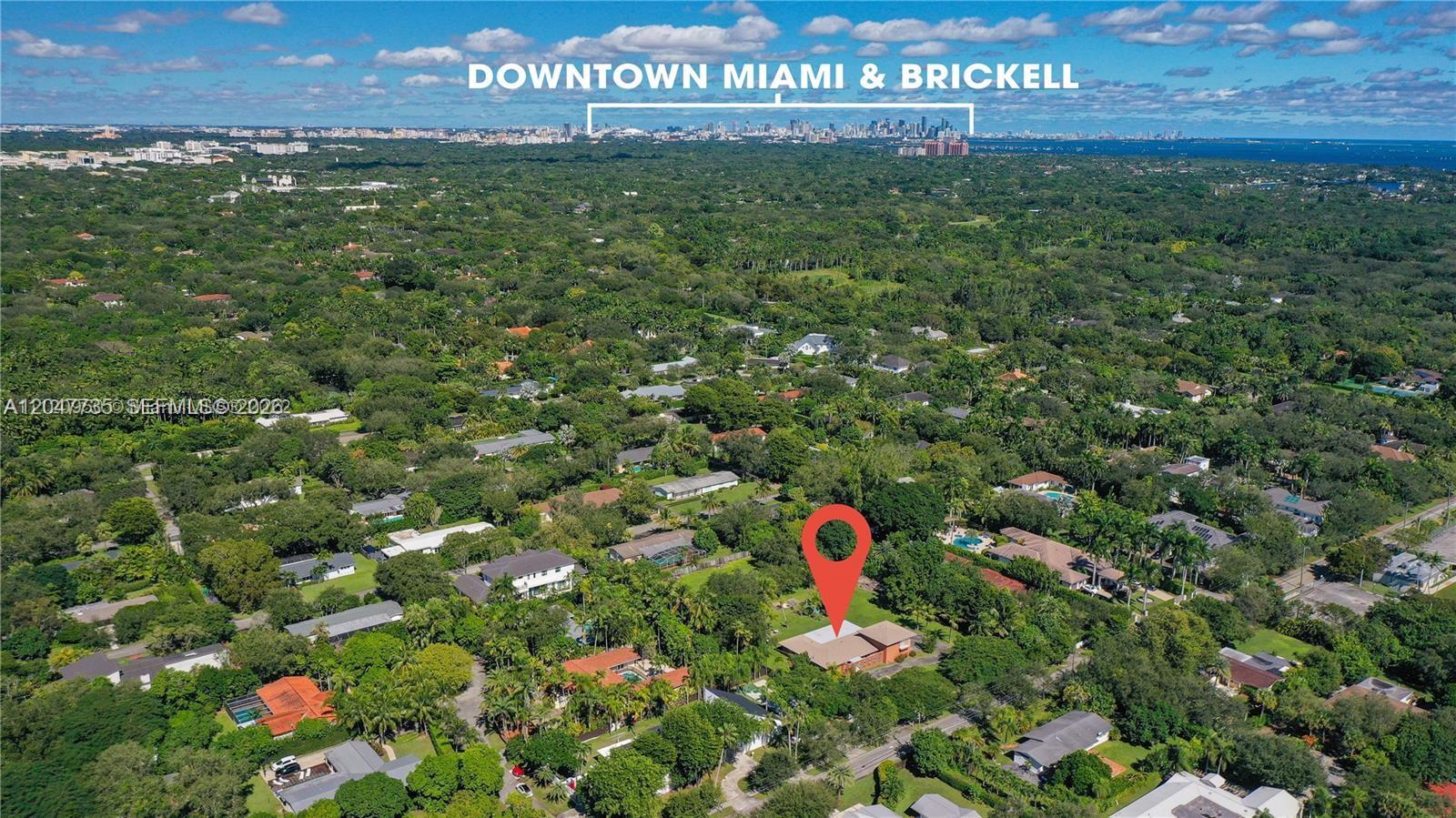 An aerial view shows a residential property marked with a pin amidst a lush neighborhood — 5865 SW 102nd St, Pinecrest FL 33156, PINECREST, FL