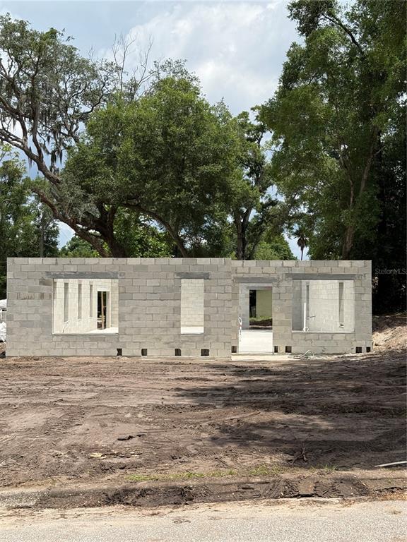 A single-story concrete block house under construction sits on a cleared, dirt lot — 931 TILDEN AVENUE, APOPKA, FL
