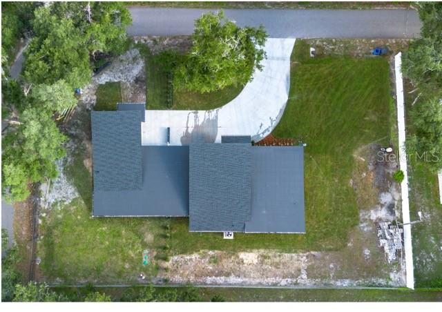 An aerial view shows a house with a dark roof, a concrete driveway, and surrounding lawn — 2902 ROBINSON ROAD, PLANT CITY, FL