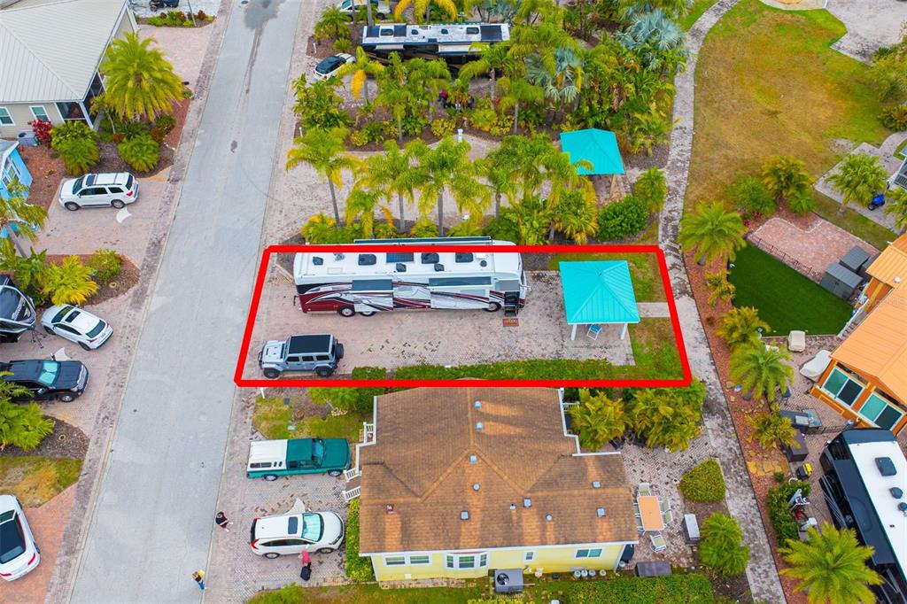 An aerial view shows a recreational vehicle parked on a gravel lot with a gazebo — 6742 AMANDA VISTA CIRCLE, LAND O LAKES, FL