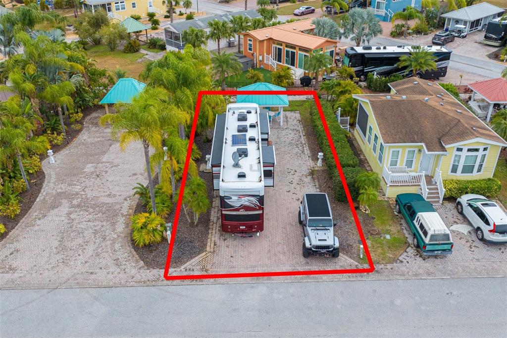 An aerial view shows a paved lot with a large RV and a parked Jeep — 6742 AMANDA VISTA CIRCLE, LAND O LAKES, FL