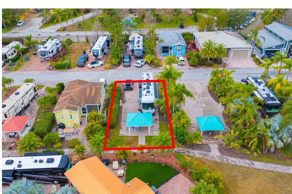 An aerial view of a paved RV lot featuring a covered patio and a motorhome — 6742 AMANDA VISTA CIRCLE, LAND O LAKES, FL