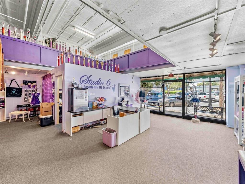 A dance studio reception area features a front desk, trophy displays, and large storefront windows — 247 E STUART AVENUE, LAKE WALES, FL