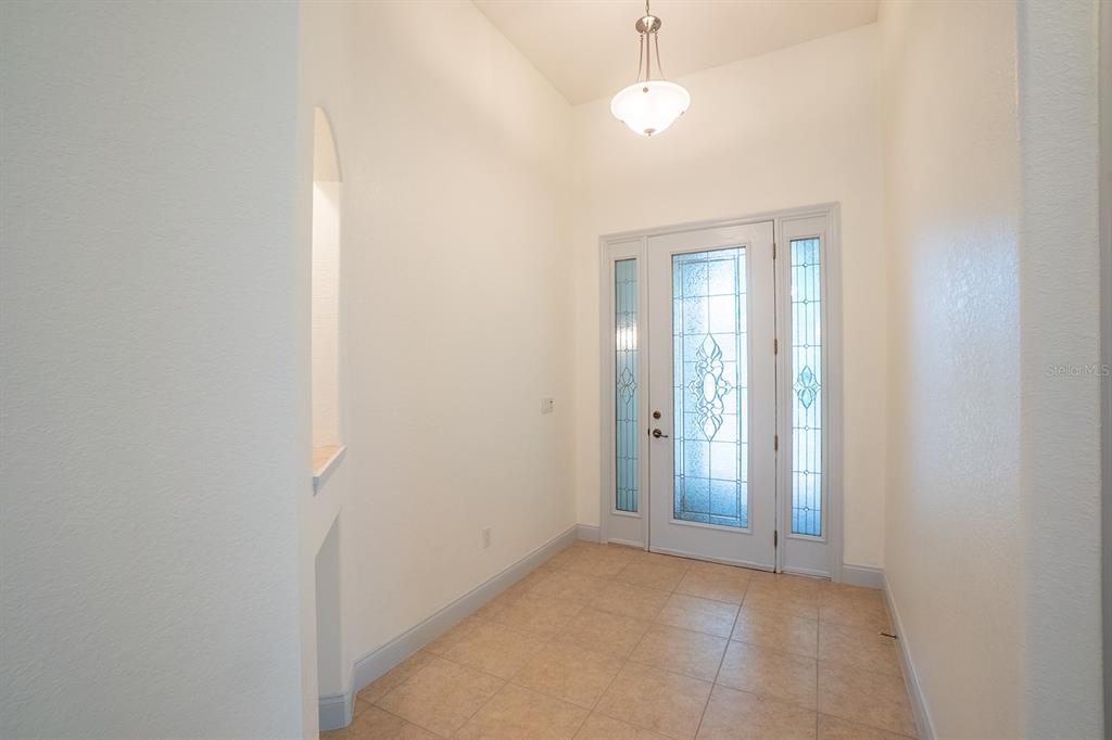 A bathroom features a white vanity, a mirror, and a bathtub with glass block windows — 79 SOUTHLAKE DRIVE, PALM COAST, FL