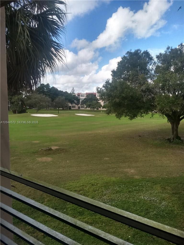 A view of a golf course with sand traps and trees from a balcony — 9410 Tangerine Pl # 204, Davie FL 33324, DAVIE, FL